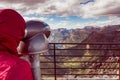 Tourist looking through binoculars in mountains, Norway