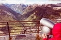 Tourist looking through binoculars in mountains, Norway