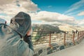 Tourist looking through binoculars in mountains, Norway
