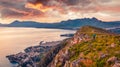 Tourist admired of sunrise on high cliff on the shore of Mediterranean sea