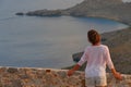 A tourist admires the panorama from the fortress of Chora, Kythera