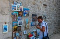 A tourist admiring artwork in Dubrovnik`s historic old town in summer, Croatia