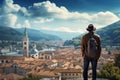 Tourist admiring beautiful view of small European town. Adventurous young person with backpack. Hiking and trekking on a nature