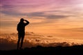 Tourist admiring breathtaking sunset views from the Mauna Kea, a dormant volcano on the island of Hawaii Royalty Free Stock Photo