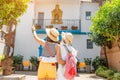 Tourist admiring great view of flowerpots on the white walls on famous Flower street in Andalusia