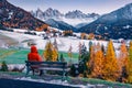 Tourist admiring of the great view of snowy hills on Santa Magdalena village with Seceda peak on background.