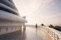 Tourist admiring Peace Pagoda against ocean at sunset