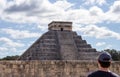 Tourist admiring the Mayan temple pyramid of Kukulkan in Chichen Itza, one of the seven wonders of the modern world