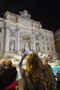 Tourist admiring the Trevi Fountain from Rome