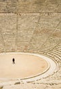 Tourist in ancient theater in Epidaurus, Greece