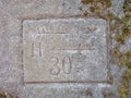 Tourist arrows and direction symbols with letters engraved into soft sandstone