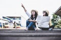 Tourist asian lifestyle friends women wearing backpack holding map, traveler siting for waiting a train, Royalty Free Stock Photo