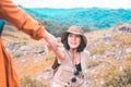 Tourist asian women getting help to friend climb a rock,Helping hands,Overcoming obstacle concept Royalty Free Stock Photo