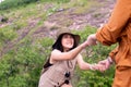 Tourist asian women getting help to friends climb a rock,Helping hands,Overcoming obstacle concept Royalty Free Stock Photo