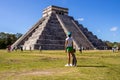 Tourist attracted by the ancient Mayan pyramid and temple of Kukulkan in Chichen Itza Royalty Free Stock Photo