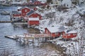 Tourist Attraction Hamnoy Fishing Village at Lofoten Islands in Norway Along With Red Rorbu Houses with Snow on Background