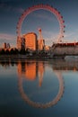 Tourist attraction London Eye reflecting in river in sunset light Royalty Free Stock Photo