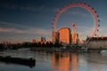 Tourist attraction London Eye reflecting in river in sunset light Royalty Free Stock Photo