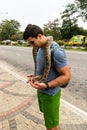 Tourist attraction, people/tourists petting a snake in Colombo, Sri Lanka, 2020 Royalty Free Stock Photo