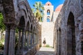 Tourist on background of cloister of the arab-norman church 