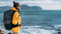 A tourist with a backpack on the background of a seascape, panorama. Portrait of a woman in tourist gear on the background