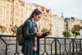 A tourist with a backpack in front of a beautiful old architecture in Prague in the Czech Republic. She looks at the map Royalty Free Stock Photo