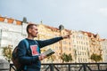 A tourist with a backpack in front of a beautiful old architecture in Prague in the Czech Republic. He looks at the map Royalty Free Stock Photo