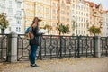 A tourist with a backpack in front of a beautiful old architecture in Prague in the Czech Republic. She looks at the map Royalty Free Stock Photo