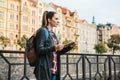 A tourist with a backpack in front of a beautiful old architecture in Prague in the Czech Republic. She looks at the map Royalty Free Stock Photo