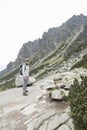 Tourist with backpack hiking in moutains