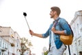 Tourist with backpack making selfies on beautiful modern buildings Royalty Free Stock Photo