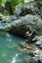 Tourist with backpack near a karstic spring Royalty Free Stock Photo