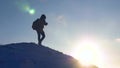 Tourist with a backpack travels on snow-capped mountains. climber gently descends from snowy mountain, slides down in