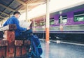 Tourist backpacker using map to travel at train station Royalty Free Stock Photo