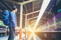 Tourist backpacker wait to travel at train station Royalty Free Stock Photo