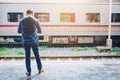 Tourist backpacker wait to travel at train station Royalty Free Stock Photo