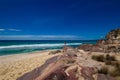 Tourist with backpacks on a large stone and enjoying Sea View. Ben Boyd national park, Australia Royalty Free Stock Photo