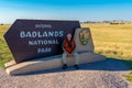 Tourist with the Badland National Park sign