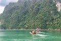 Tourist on bamboo raft. Khao Sok National Park, Ratchaprapa Dam Royalty Free Stock Photo