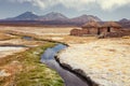 Tourist bathing in hot springs, Sajama national park, with volcano Parinacota and Pomerape in the background, Bolivia