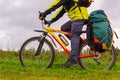 Tourist bike riding through the field, closeup