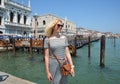 VENICE, ITALY - August 22, 2019: Tourist blond curly woman on the Piazza San Marco near Grand Chanal in Venice Royalty Free Stock Photo