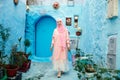 Tourist on a blue street in Chefchaouen, Morocco Royalty Free Stock Photo