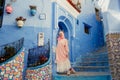 Tourist on a blue street in Chefchaouen, Morocco Royalty Free Stock Photo
