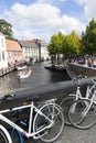 Tourist boat in bruges canal near old bridge on sunny summer day