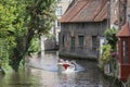 Tourist boat in bruges canal on sunny summer day