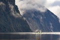 Tourist boat cruising in milford sound fjordland national park Royalty Free Stock Photo
