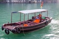 A tourist boat cruising on the waters of Ha Long Bay in Vietnam Royalty Free Stock Photo