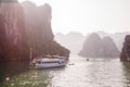 A tourist boat cruising on the waters of Ha Long Bay in Vietnam Royalty Free Stock Photo