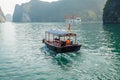 A tourist boat cruising on the waters of Ha Long Bay in Vietnam Royalty Free Stock Photo